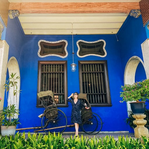 Standing in front of a rickshaw at the Blue Mansion